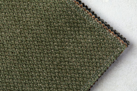 textured background or wallpaper from rough fabric of green lime color and a blank space