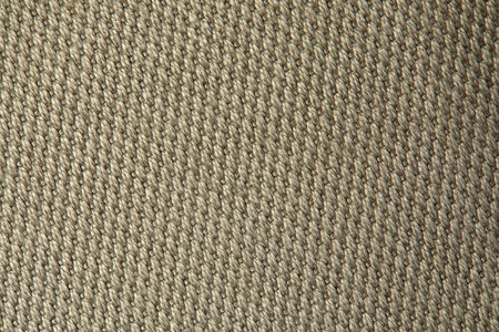 Knitted texture. Texture of jacquard fabric with gray beige geometric pattern. Crochet mosaic...