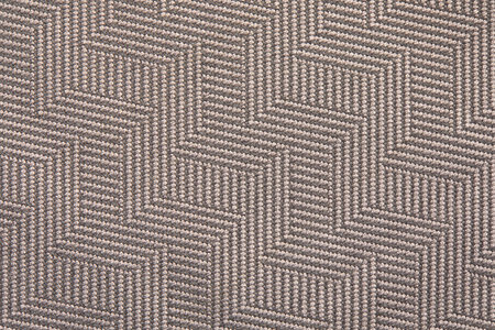 Knitted texture. Texture of jacquard fabric with gray geometric pattern. Crochet mosaic pattern.