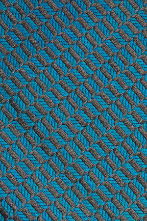 Knitted texture. Texture of jacquard fabric with gray blue geometric pattern. Crochet mosaic...