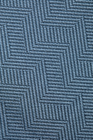 Knitted texture. Texture of jacquard fabric with gray blue geometric pattern. Crochet mosaic...