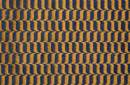 fabric in mustard color with geometric patterns. mustard knitted texture, background knitted mustard...
