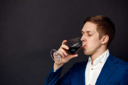 Male sommelier tasting red wine. Winemaking. Occupations.の写真素材