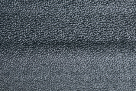 Dark gray leather texture closeup, useful as background