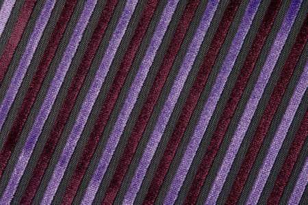 Corduroy background with lines pattern close up. Texture of violet corduroy textile - useful as background. Diagonal line texture.の写真素材