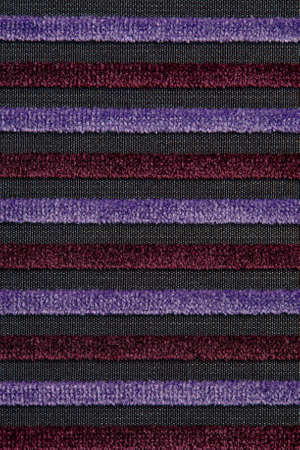 Corduroy background with lines pattern close up. Texture of violet corduroy textile - useful as background. Canvas horizontal line texture.の写真素材