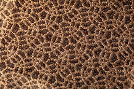 Abstract circular print background on cotton fabric in golden brown tone