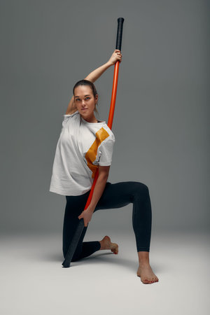 beautiful girl in sports uniform is training kung fu in the studio, fighter athlete, practicing...