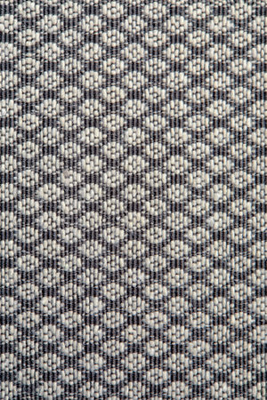 Knitted texture. Texture of jacquard fabric with gray geometric pattern. Crochet mosaic pattern