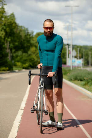 A cyclist in motion. Bike ride along the embankment along the river.の写真素材