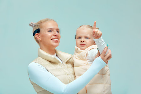 young woman with little girl wearing head mount display and futuristic GUI, smart glasses, graphical user interface, heads up display, Internet of Thingsの写真素材