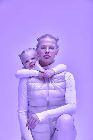 Young girl kid child with mother wearing smart glasses and explore alternative reality. Cyber space and virtual gaming. Discover future technology on white background bannerの写真素材