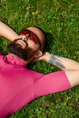 Bicyclist taking rest in the green grasses. Summer time, great mood.の写真素材