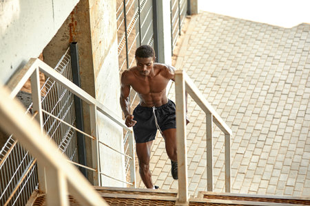 Sport Motivation. Black Male Athlete Running Up On Urban Stairs Outdoors, Enjoying Morning Workout,...