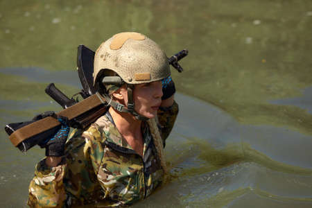Full military experience - One day commando - running through the water with automatic rifle replicaの写真素材