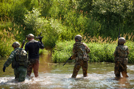Special forces soldier with weapon take part in military maneuver. War, army, technology and people...