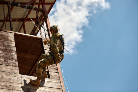 Special forces fighter descends from a skyscraper to storm the apartment. Police, counter terrorism concept. Mixed mediaの写真素材