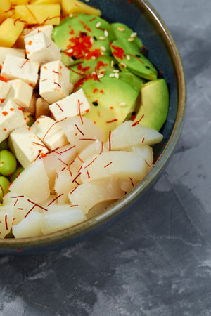 Top view on poke salad with tuna and green vegetable in the bowls on gray background. Copy space.の写真素材
