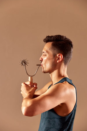 Young man testing breathing function by breath a cizer. Take care about health.