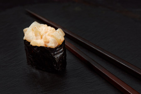 Warm rolls with tuna, salmon, perch, eel, tobiko caviar, nori, rice, cucumber on black background.の写真素材