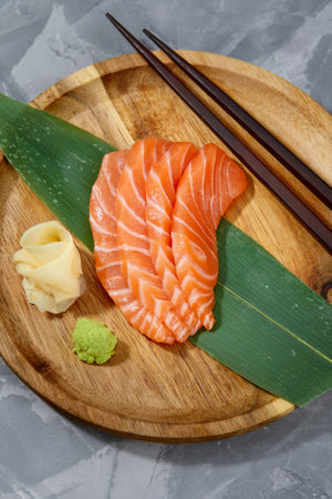 Japanese food style, Top view of salmon slice on bamboo leaves, Salmon sashimi is Japanese traditional, Selective focus, Fish slices top viewの写真素材
