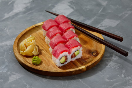 Sushi roll Maguro with tuna, shrimp, salmon, smoked eel, avocado, philadelphia cheese on black background. Sushi menu. Japanese food.の写真素材
