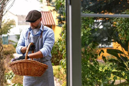 A man farmer holds vegetables in his hands. Selective focus. Food.の写真素材