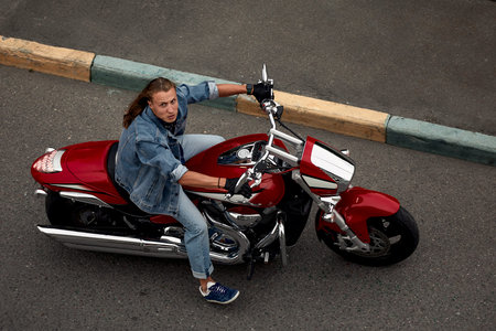 Biker rides a motorcycle in an urban landscape.の写真素材