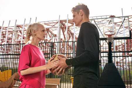 Diversity guy and girl playing basketball on the city playgroundの写真素材
