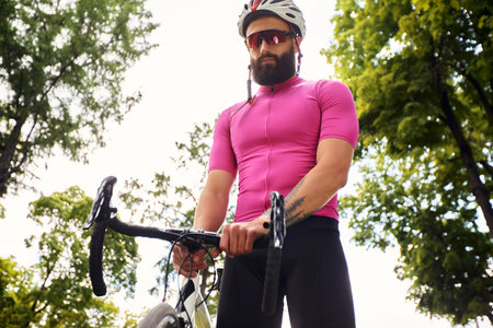 Attractive young man rides a bikeの写真素材