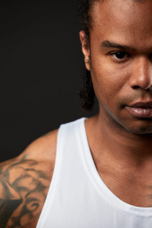 portrait of African-American athlete man boxing on black backgroundの写真素材