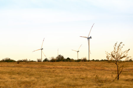 Wind energy. Wind power. Sustainable, renewable energy. Wind turbines generate electricity. Windmill farm on mountain with sunset sky. Green technology. Renewable resource. Sustainable development.の写真素材