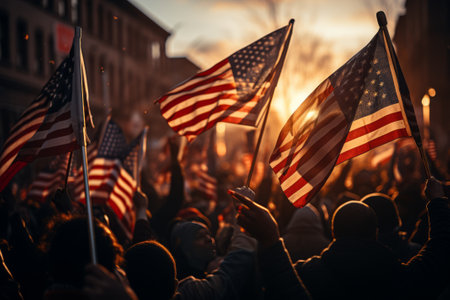 A huge crowd of people marches along a city street with American flags. The Stars and Stripes flutter over people's heads. Independence Day 4th of July concept. The US main holiday. National prideの素材