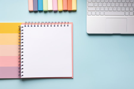 Business stationery on blue trending background. Notepad, colorful stickers, pens, pencils, computer keyboard, indoor plants, a cup of coffee. Top view, flat lay. Mockup, copy space.の素材