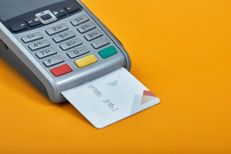 Payment by credit card. Terminal on yellow background copy spaceの写真素材