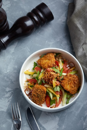 Salad with Fried chicken nuggets and vegetables