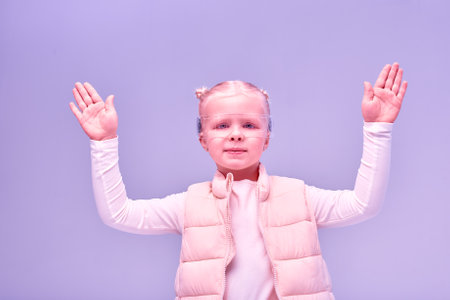 Young girl kid child wearing smart glasses and explore alternative reality. Cyber space and virtual gaming. Discover future technology on pink background bannerの写真素材