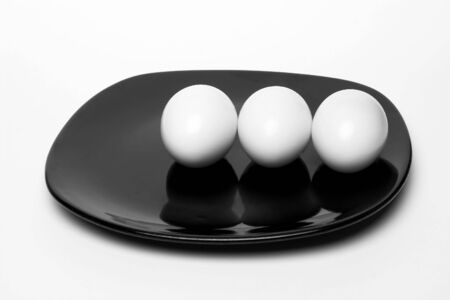 Boiled eggs on black plateの写真素材