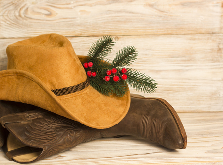 Cowboy Christmas.American West traditional boots and hat on wood background textureの写真素材