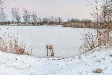 broken bridge in a frozen lakeの写真素材