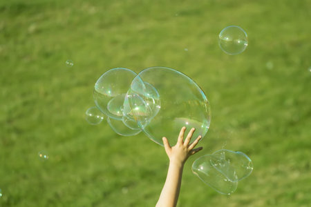 Hand on soap bubbles