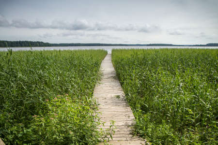Wooden walkway to the large lakeの写真素材