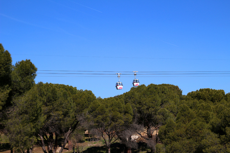 2 cable cabins in the blue sky passing each other.の写真素材