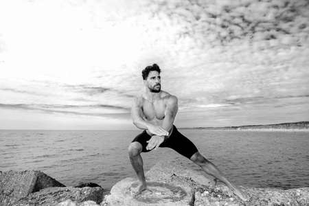 Fitness man having workout on the beach.の写真素材