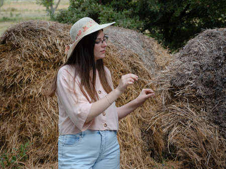 girl's playing with straw in the farmの写真素材