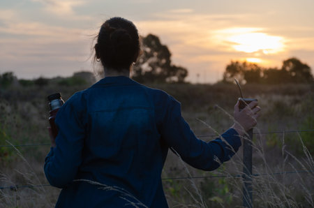 Girl's watching sunset and drinking mate in the countryside. Girl portrait.