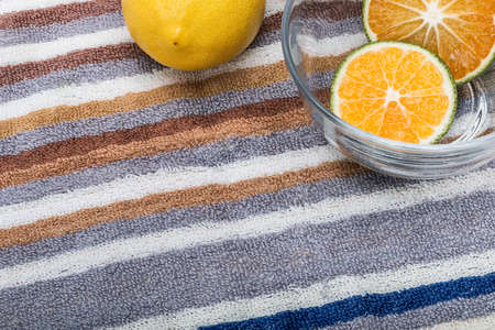 Lemon and cut oranges placed on the tableの写真素材