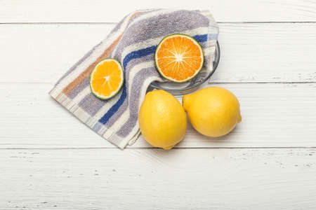 Lemon and cut oranges placed on the tableの写真素材