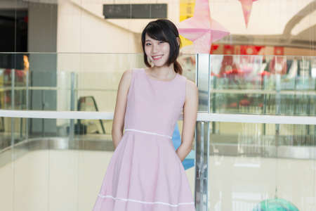 Girl standing in the mall and smilingの写真素材