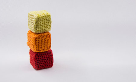 baby cubes for the game in the knitted cover on a white backgroundの写真素材